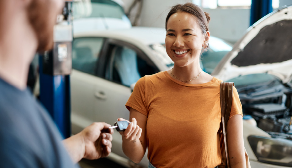 A donor holding the keys to a vehicle they are consigning