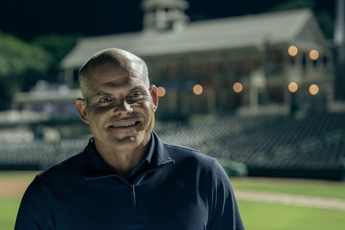 Supporter smiling in a community stadium