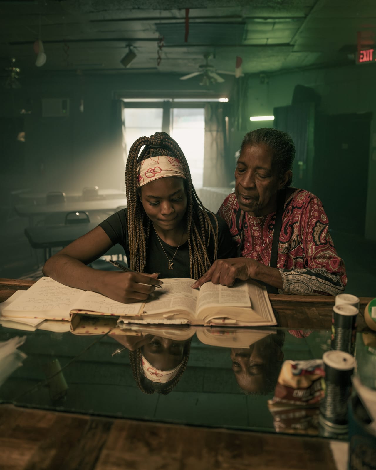 Student studying alongside her mentor at a table