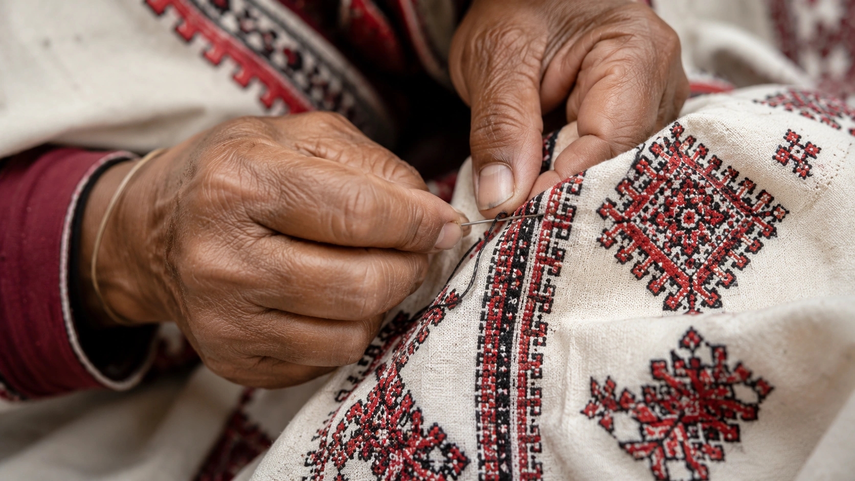Close-up of traditional Toda embroidery being created using counted-thread techniques