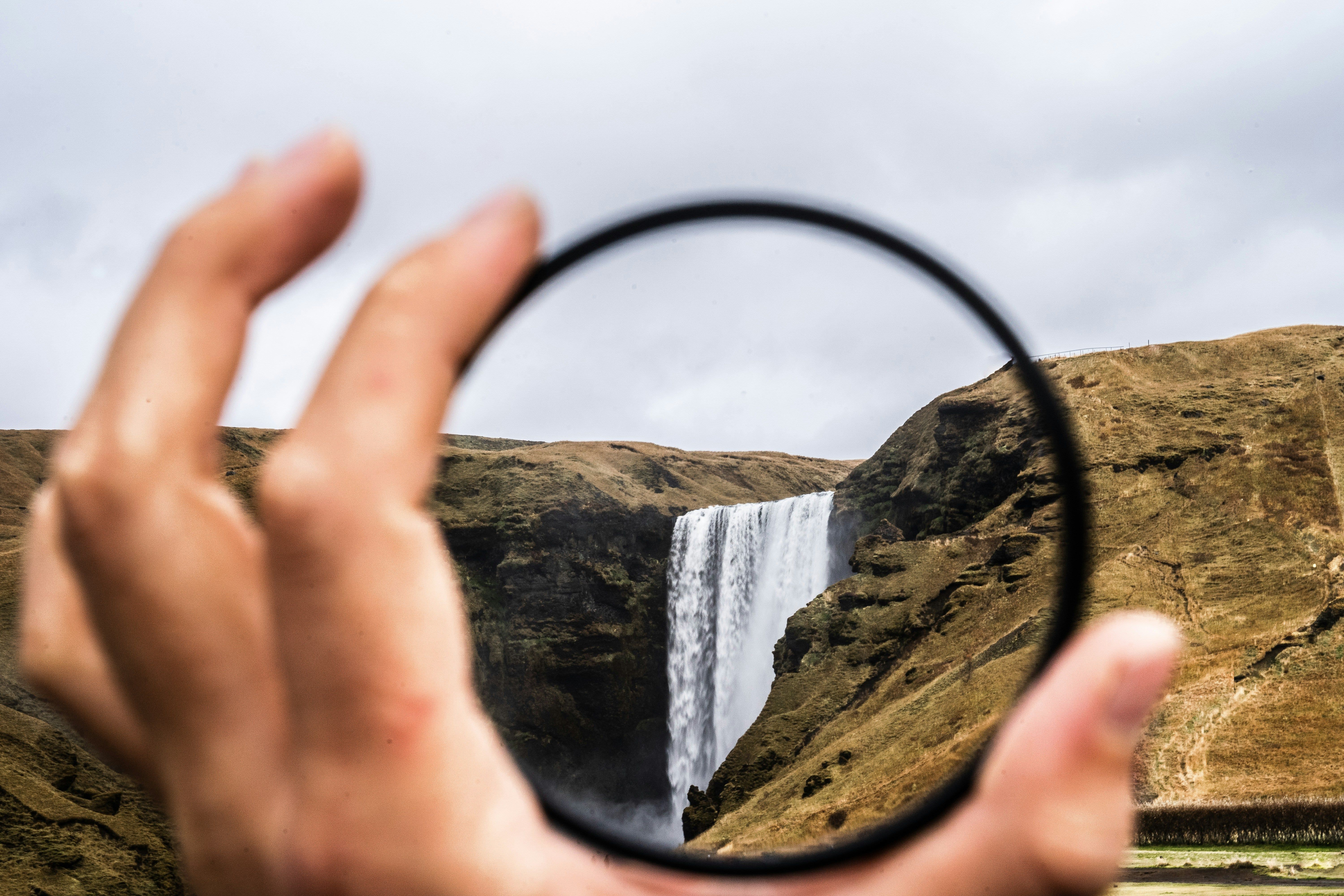 Photographer using ND filters for long exposure waterfall photography
