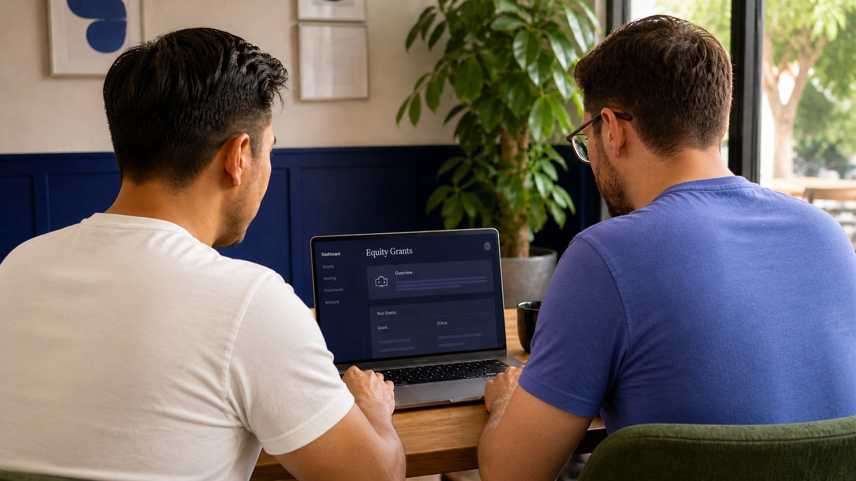 Two gay men reviewing financial documents together on a laptop in a modern, warmly lit office space.