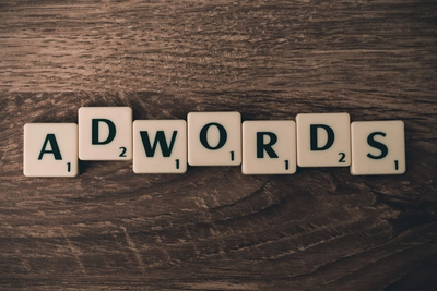 Scrabble tiles spelling “ADWORDS,” representing Google Ads and pay-per-click advertising.