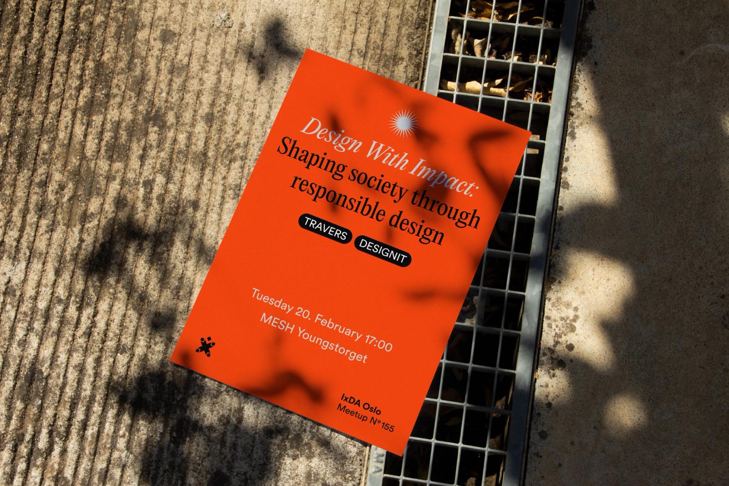 Photo of poster on the ground with the text "Design with Impact – Shaping society through responsible design"