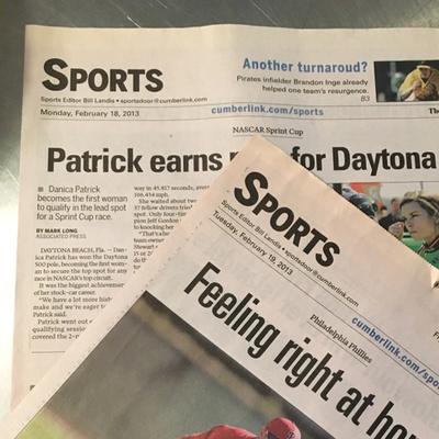 Two newspaper sports section front pages