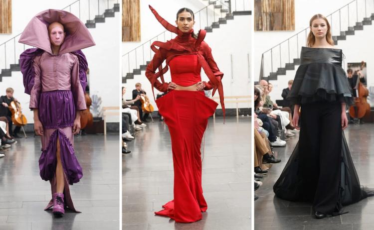 Tre modeller på catwalk: en i lila med stor huva, en i röd klänning med skulpturala band vid axlarna, en i svart offshoulderlook.