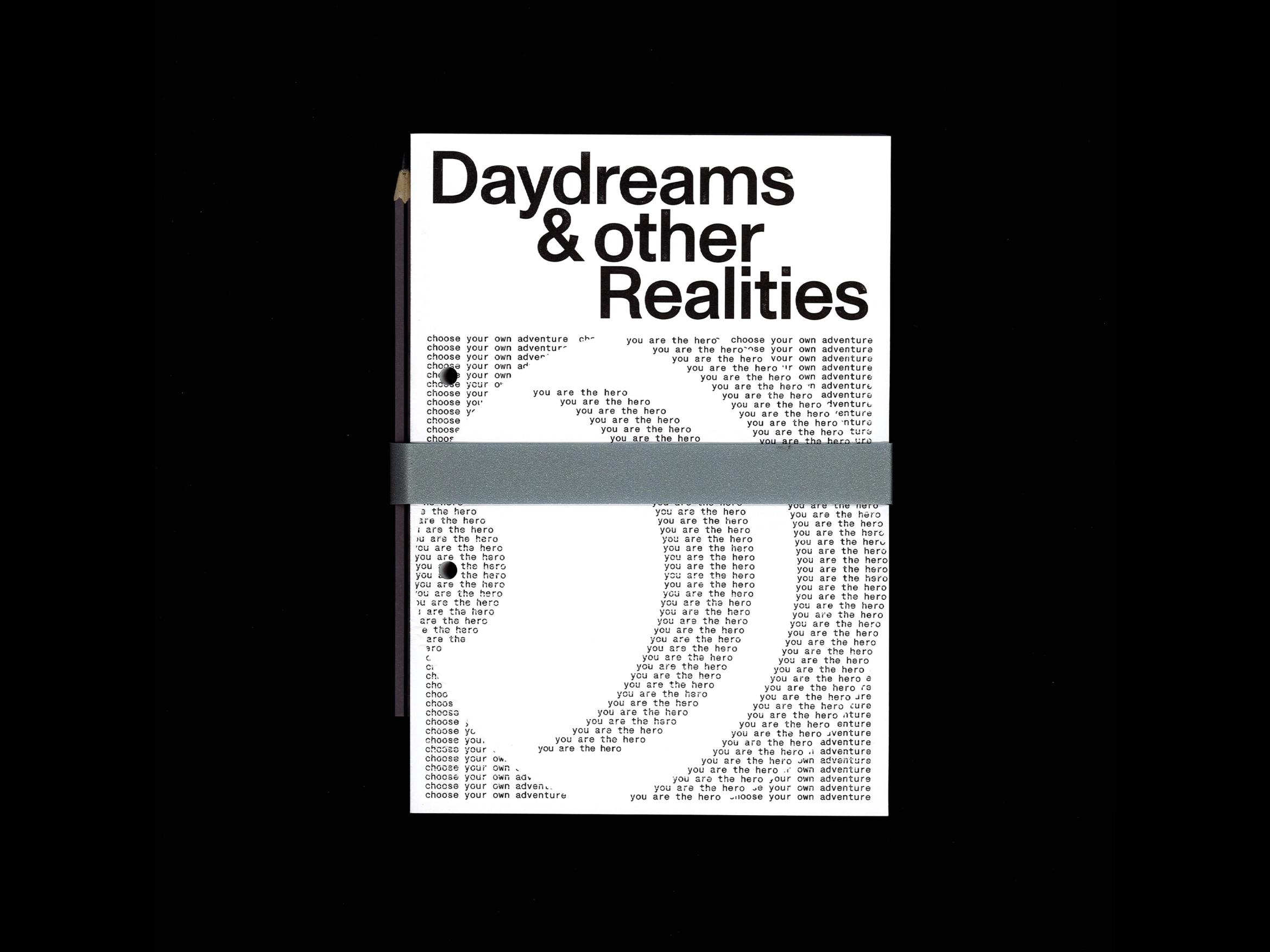 Häftet "Daydreams & other Realities", omslaget täckt av upprepade rader "you are the hero" i skrivmaskinsstil.