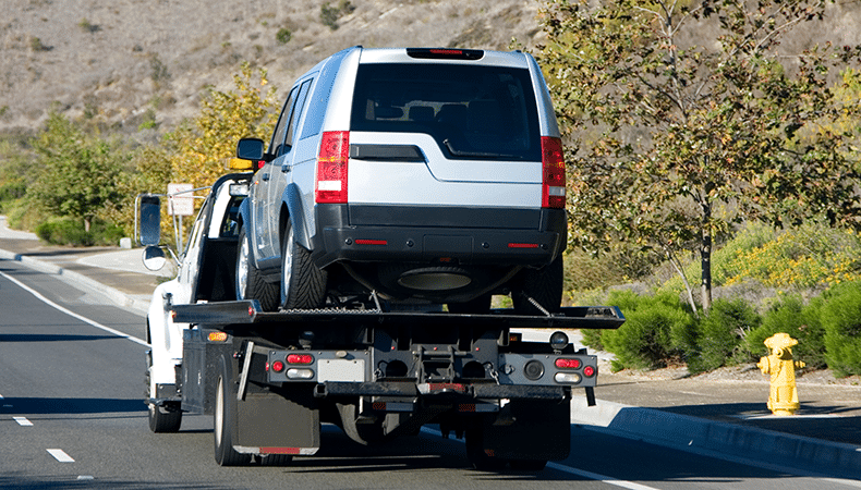 luxury vehicles on open transport trailer