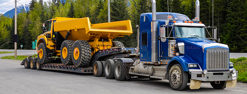 flatbed trailer carrying heavy equipment