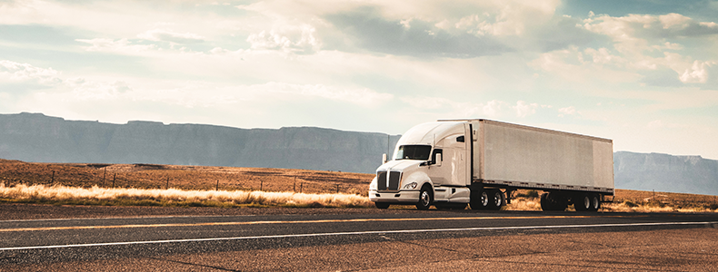 freight truck driving down the road