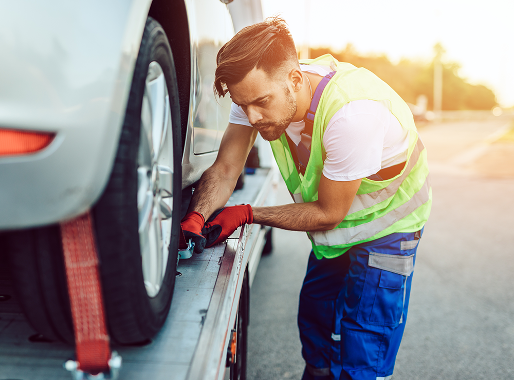 carrier loading a car on a trailer