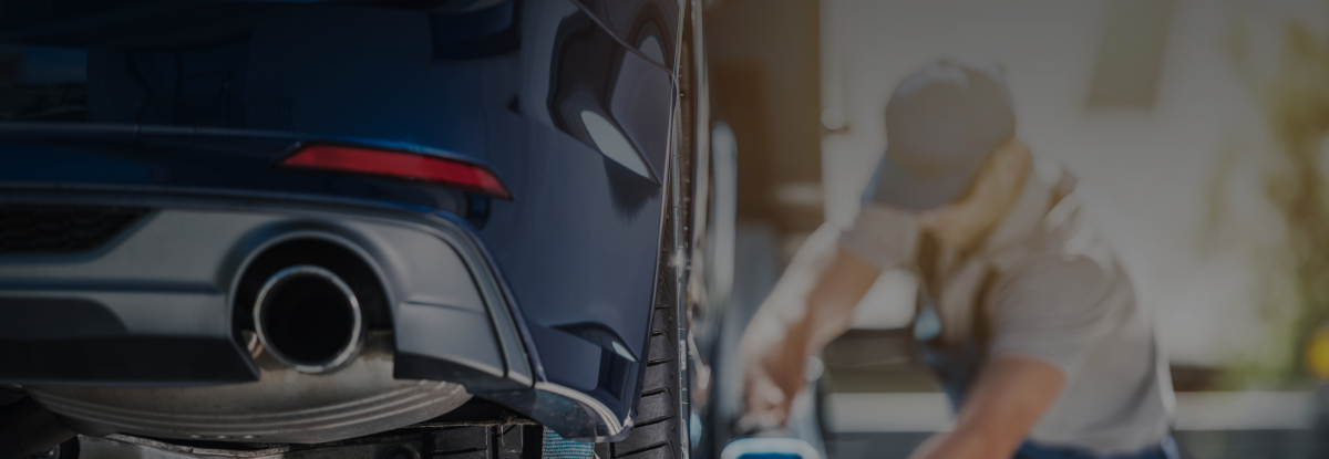 man loading car onto trailer
