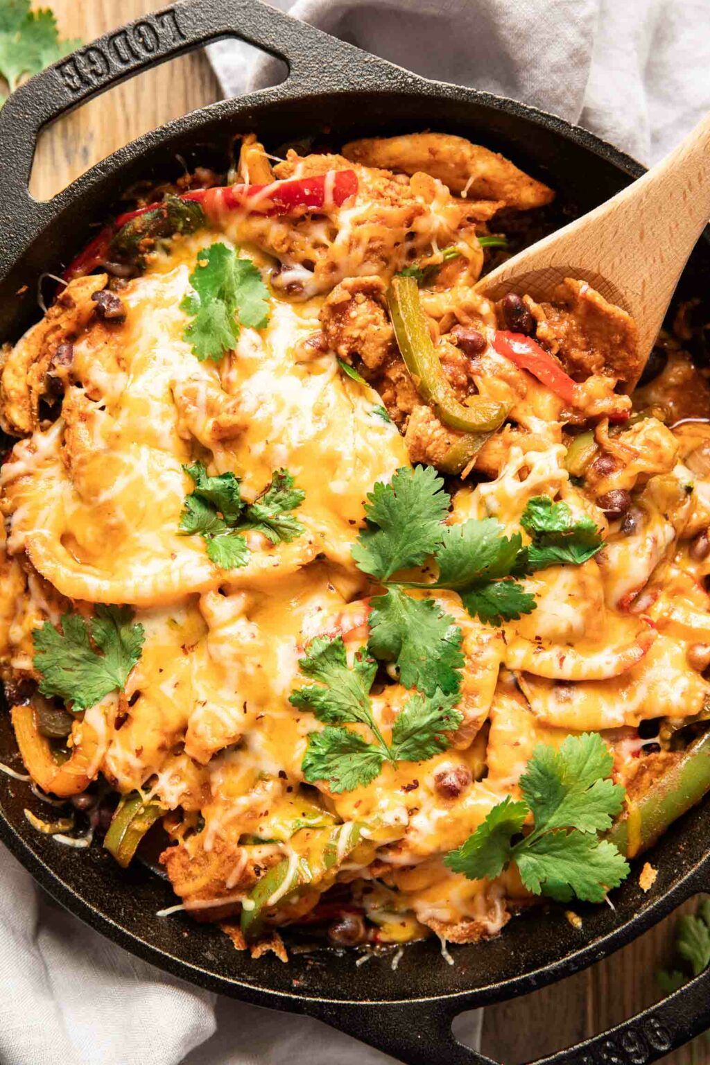 Top shot photo of chicken fajita casserole with a spoon.