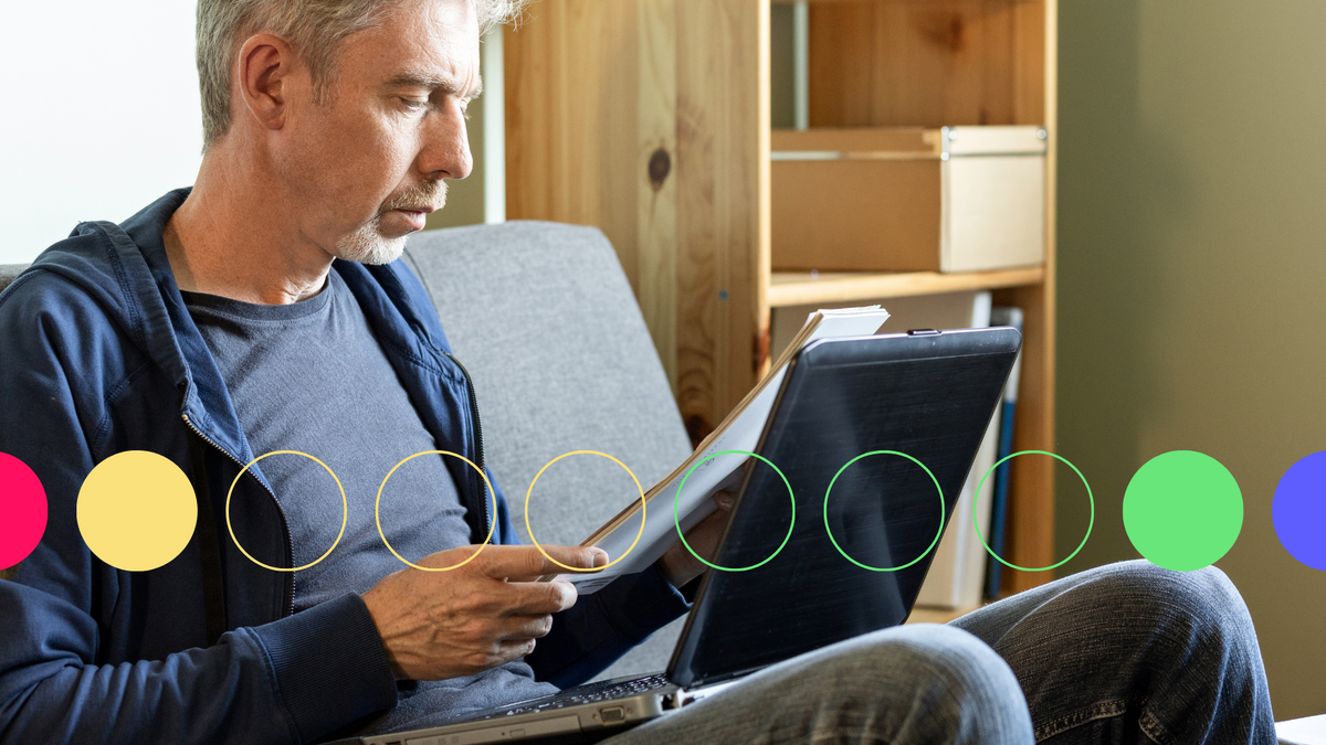 A photo of an older man taking notes on a tablet