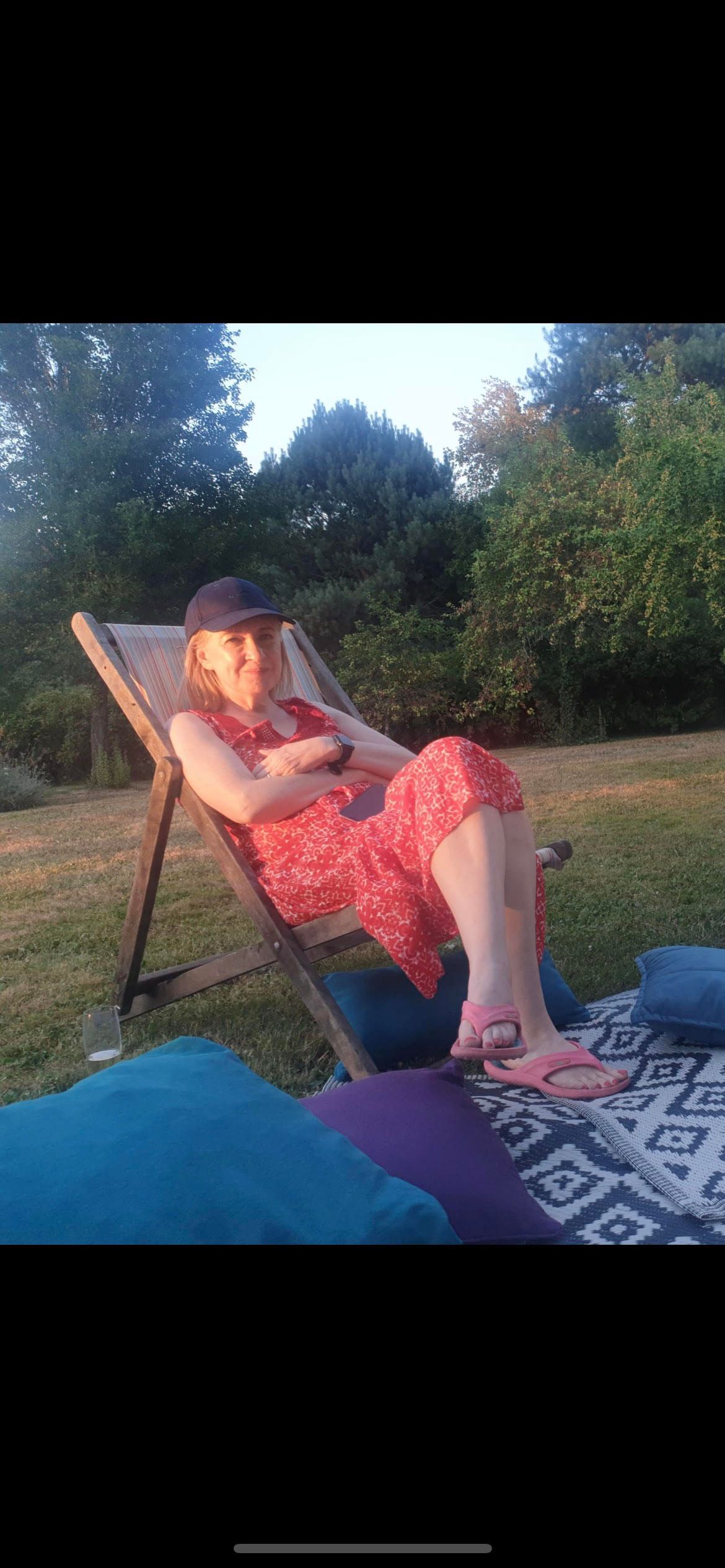 Helen relaxes on a garden lounge chair now that she has sorted her finances out