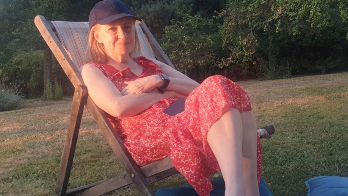 Helen relaxes on a garden lounge chair now that she has sorted her finances out