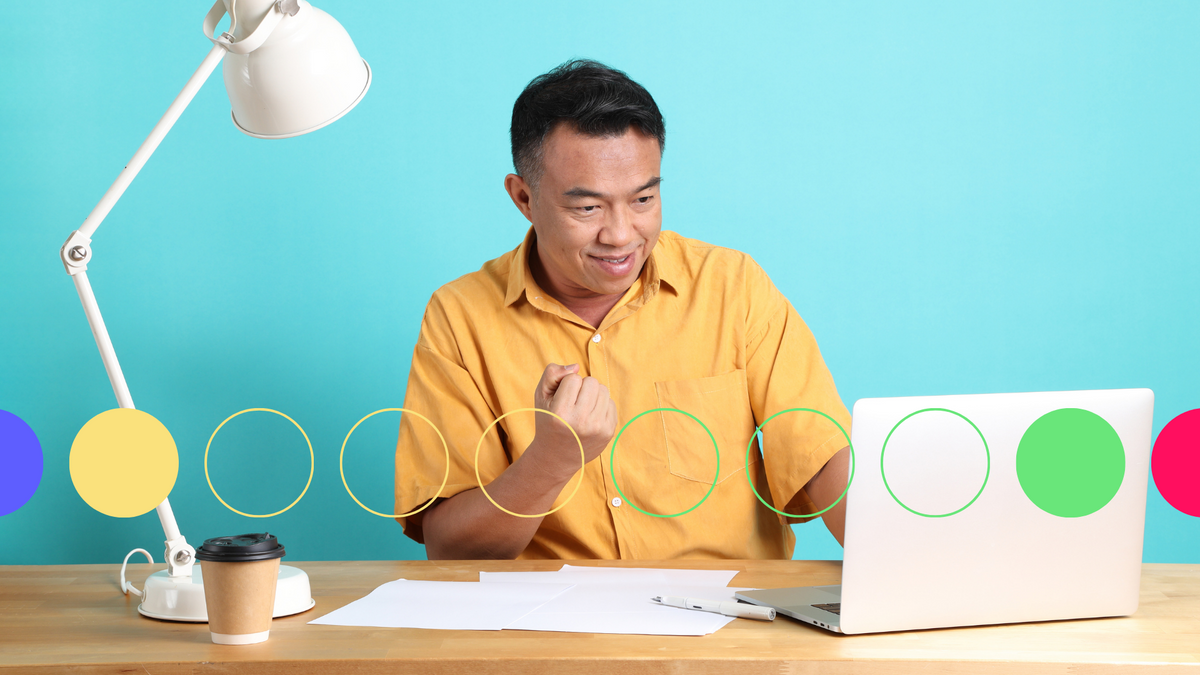 A photo of a middle aged man working on a laptop