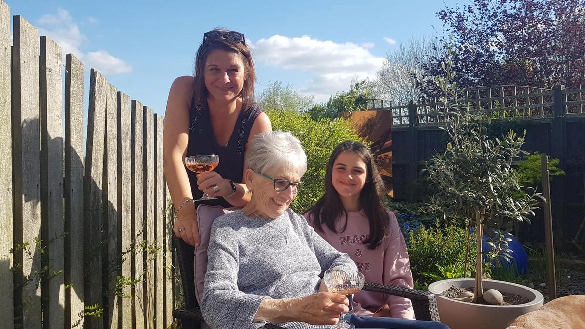 Photo of article writer Steph Smith drinking cocktails in a garden with her mum and daughter