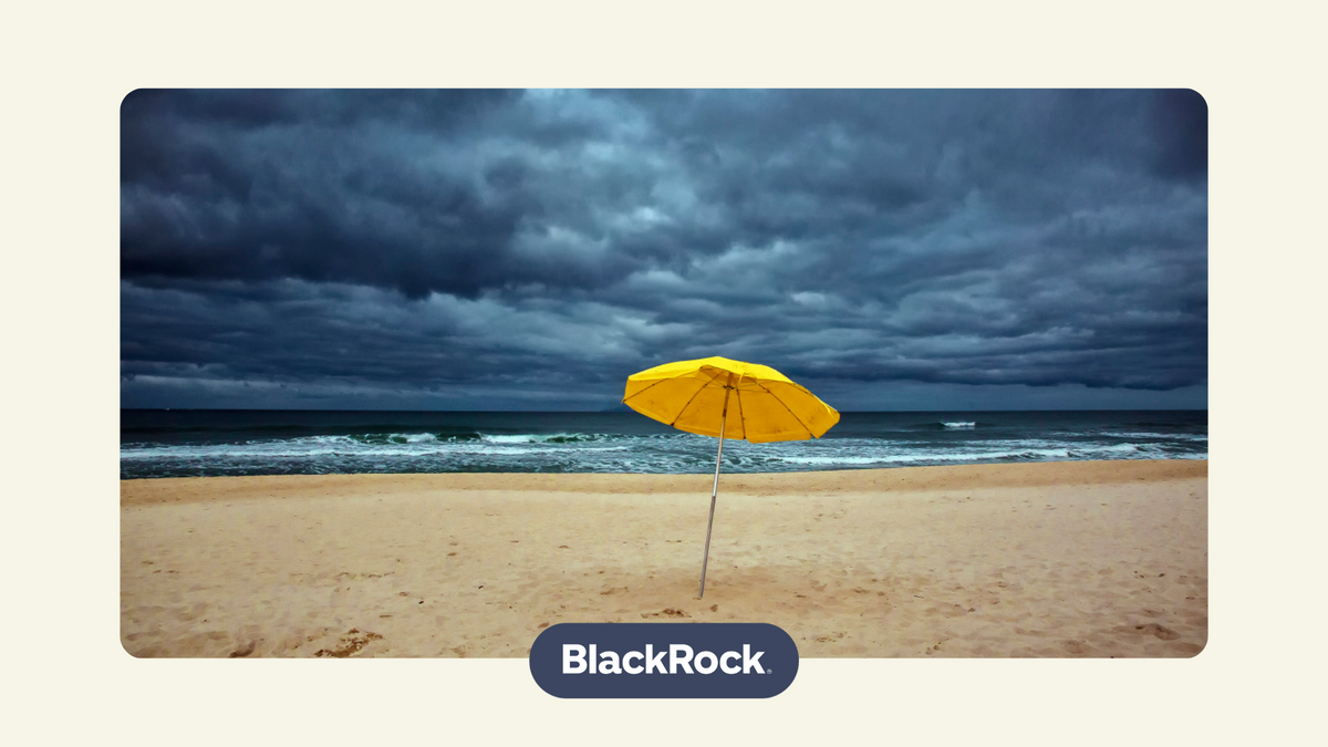 a single yellow umbrella on a cloudy, stormy beach