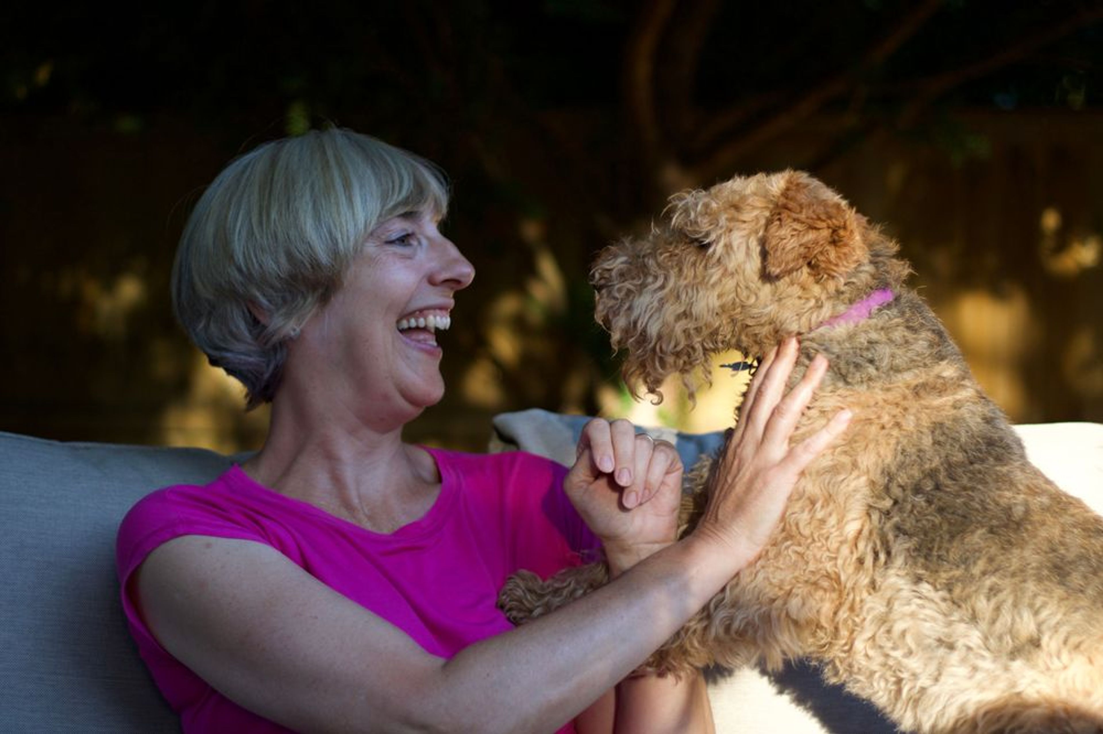 Article writer Carole Haswell laughing with her pet dog