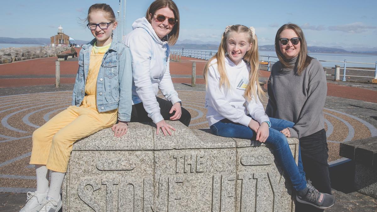 A photo of co-parents Annabel and Tarnia with their two daughters on a family day out