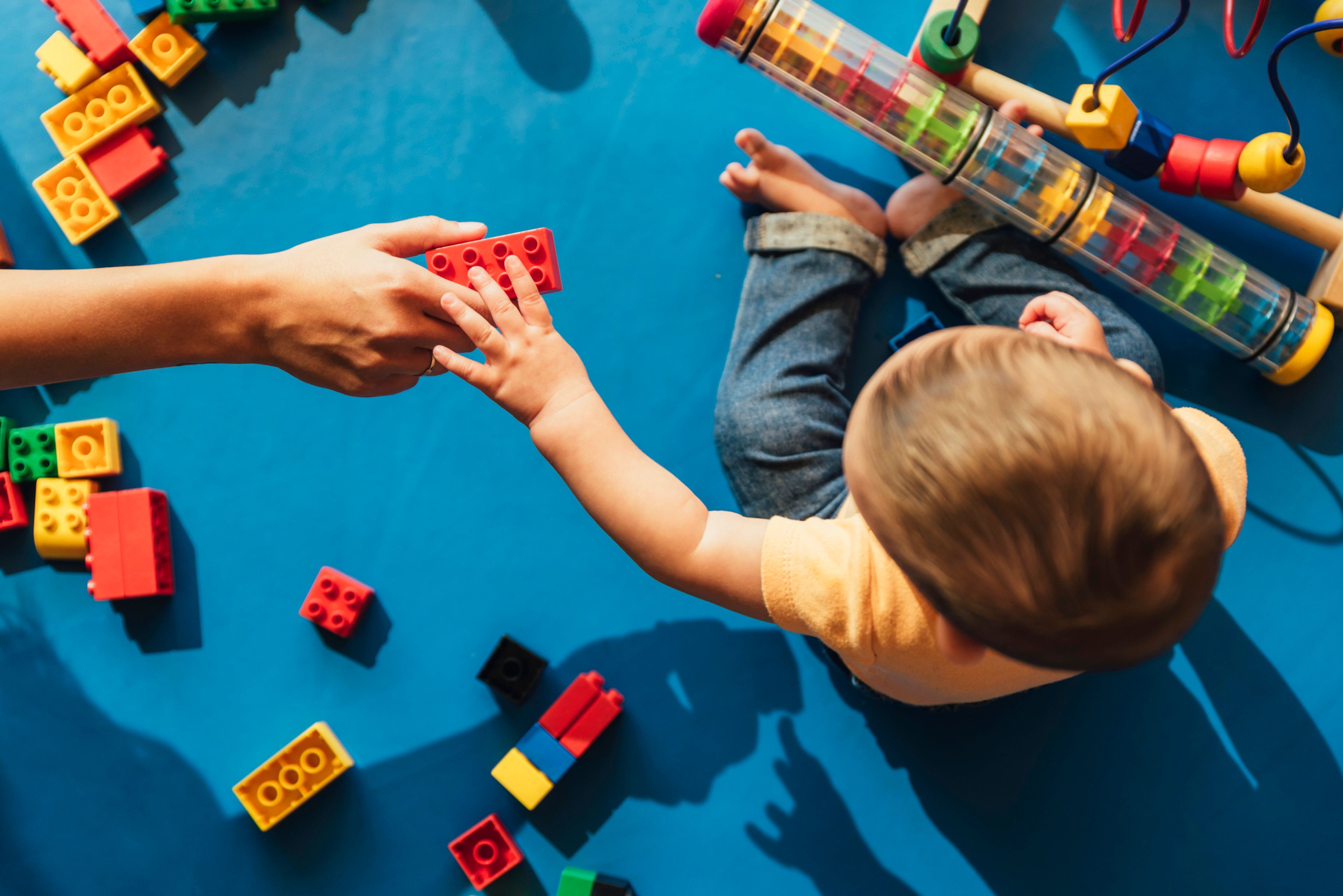 A hand holding the last remaining jigsaw left in a puzzle