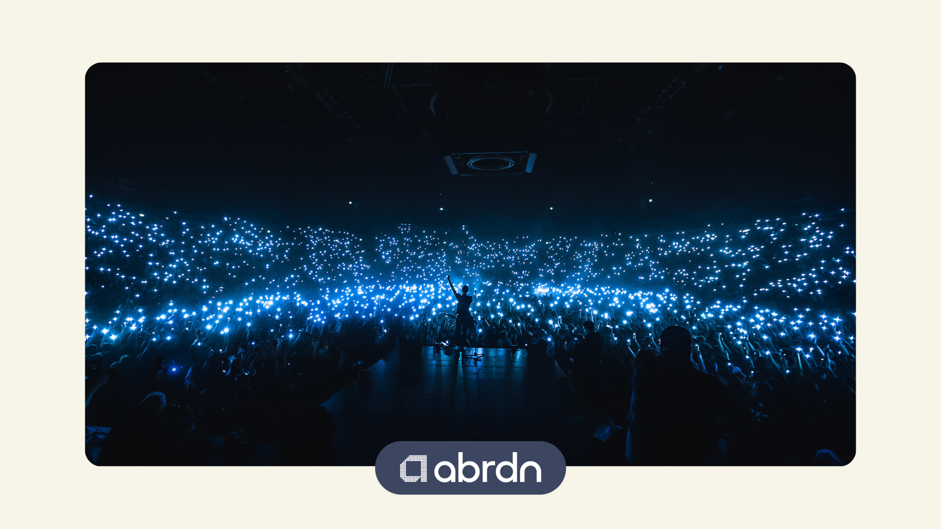 Taylor Swift dancing at her concert surrounded by a sea of fairly-lights