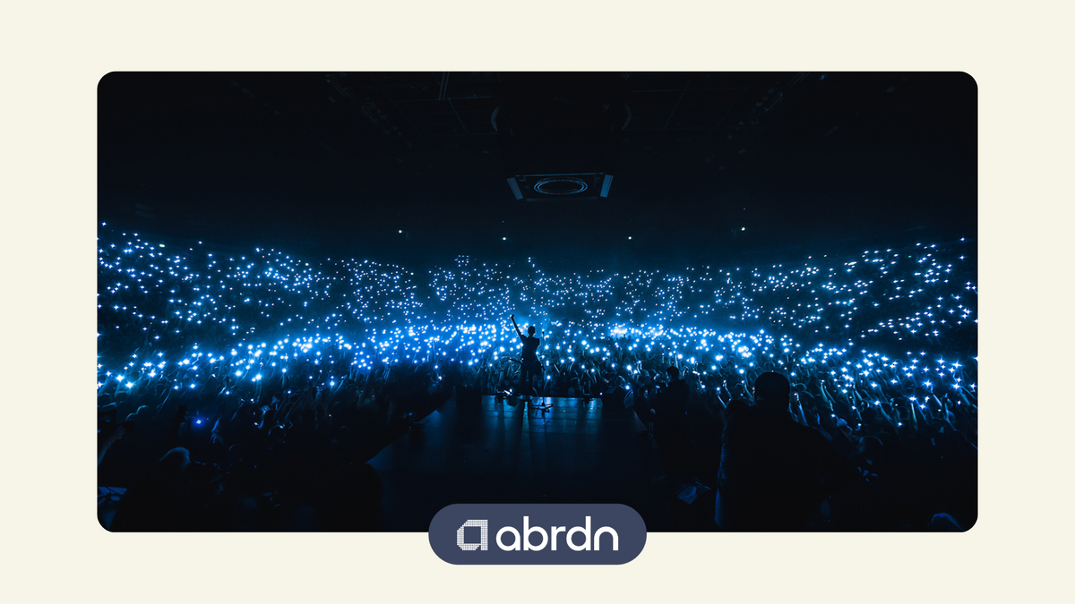Taylor Swift dancing at her concert surrounded by a sea of fairly-lights