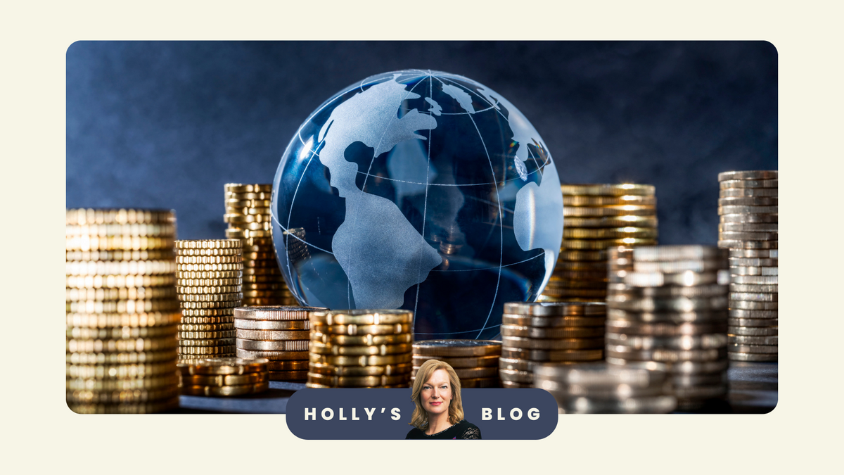 An image of a blue globe nestled amongst stacks of pound coins