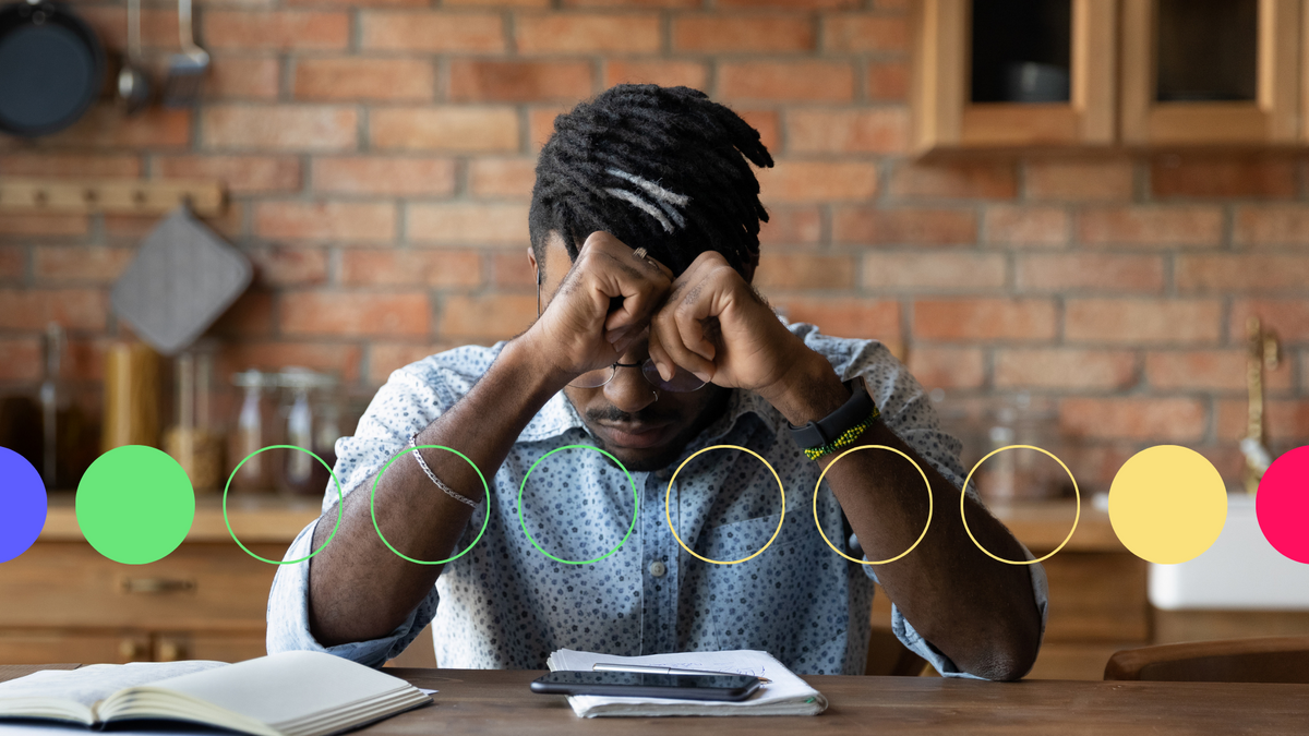 An image of a stressed middle aged man with his head in his hands