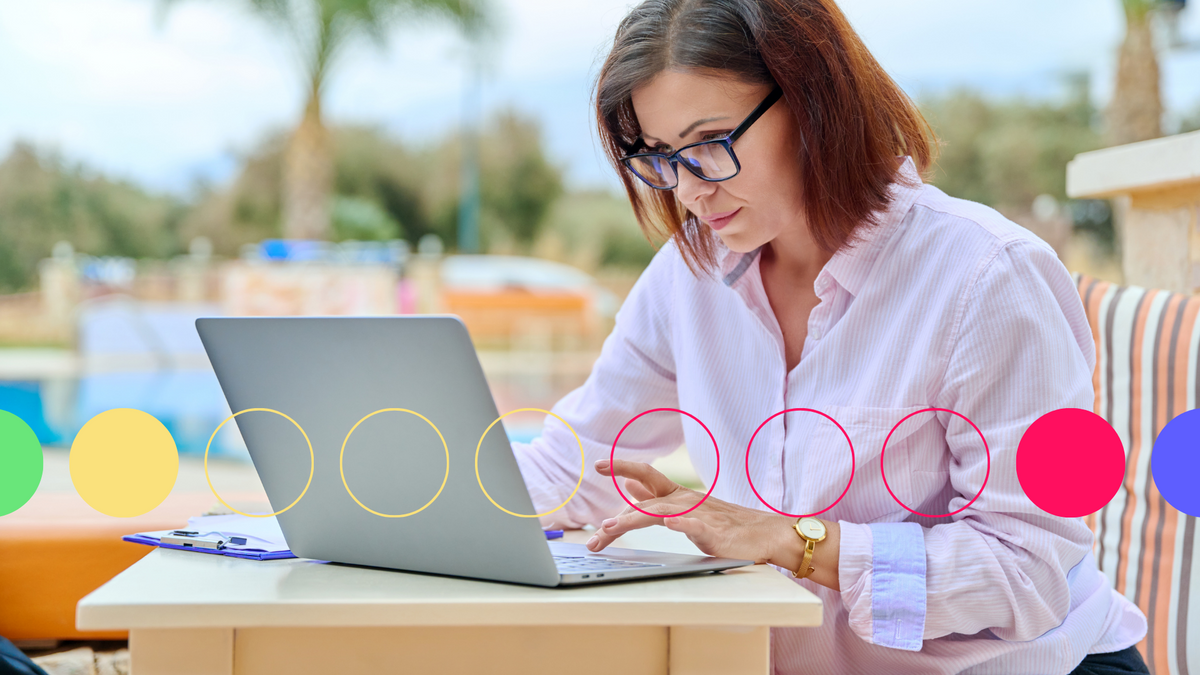A photo of a middle aged woman working on a laptop