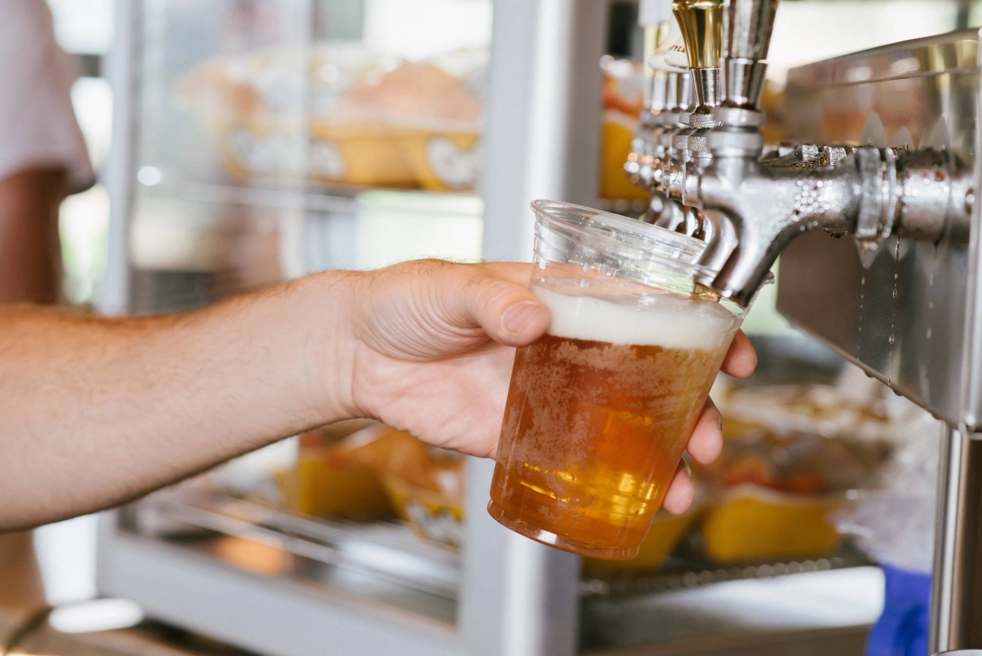 a glass being filled with beer from the tap