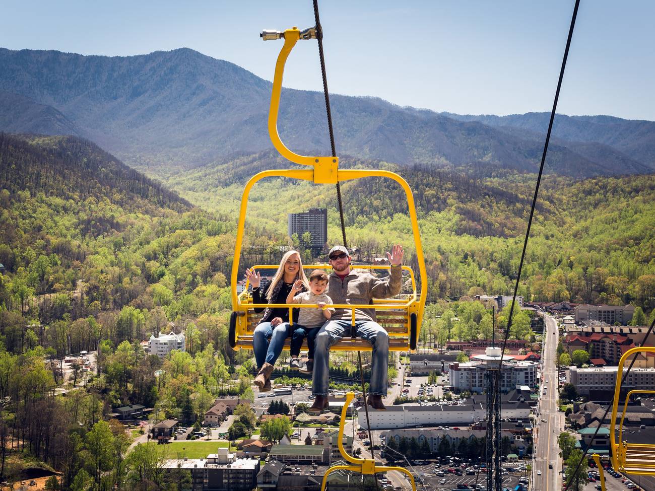 A family of three riding the SkyLift.
