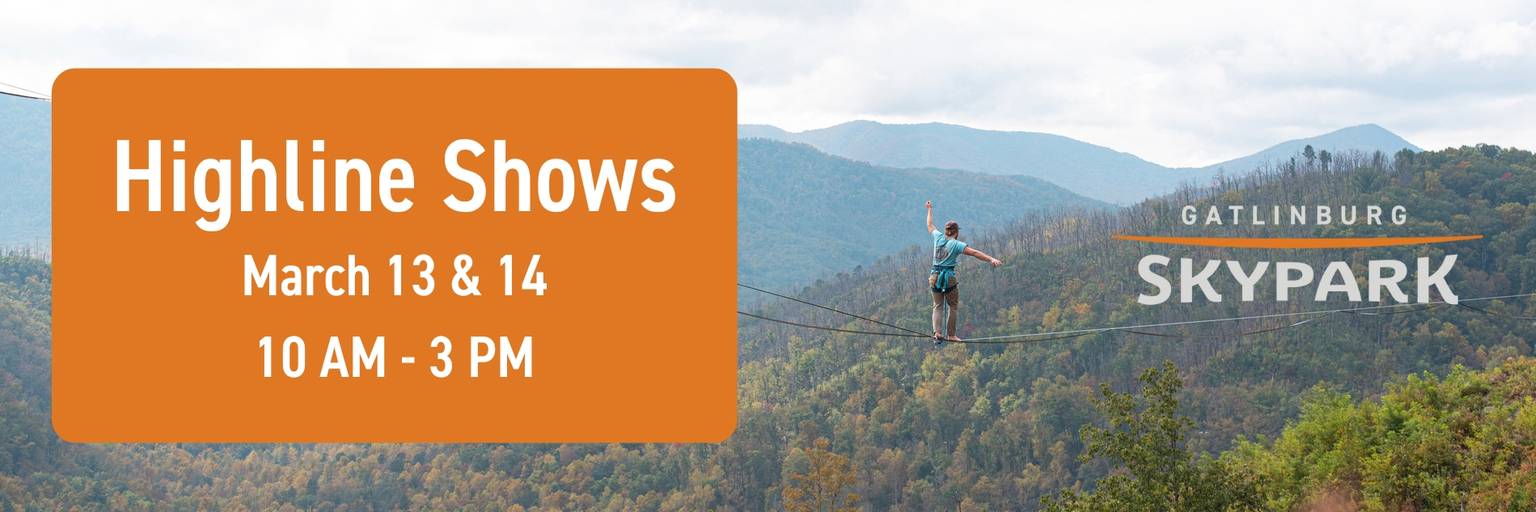 A highliner walking a slackline across the valley of the SkyBridge.