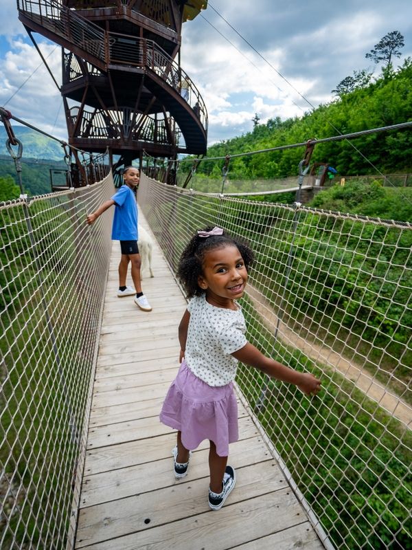 Kids crossing the Tulip Tower rope bridges.