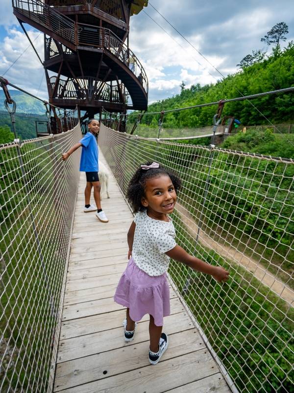 Kids crossing the Tulip Tower rope bridges.