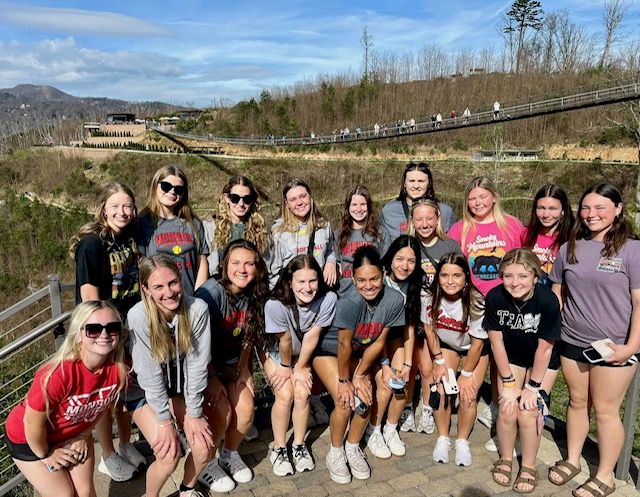 group photo with skybridge in the background