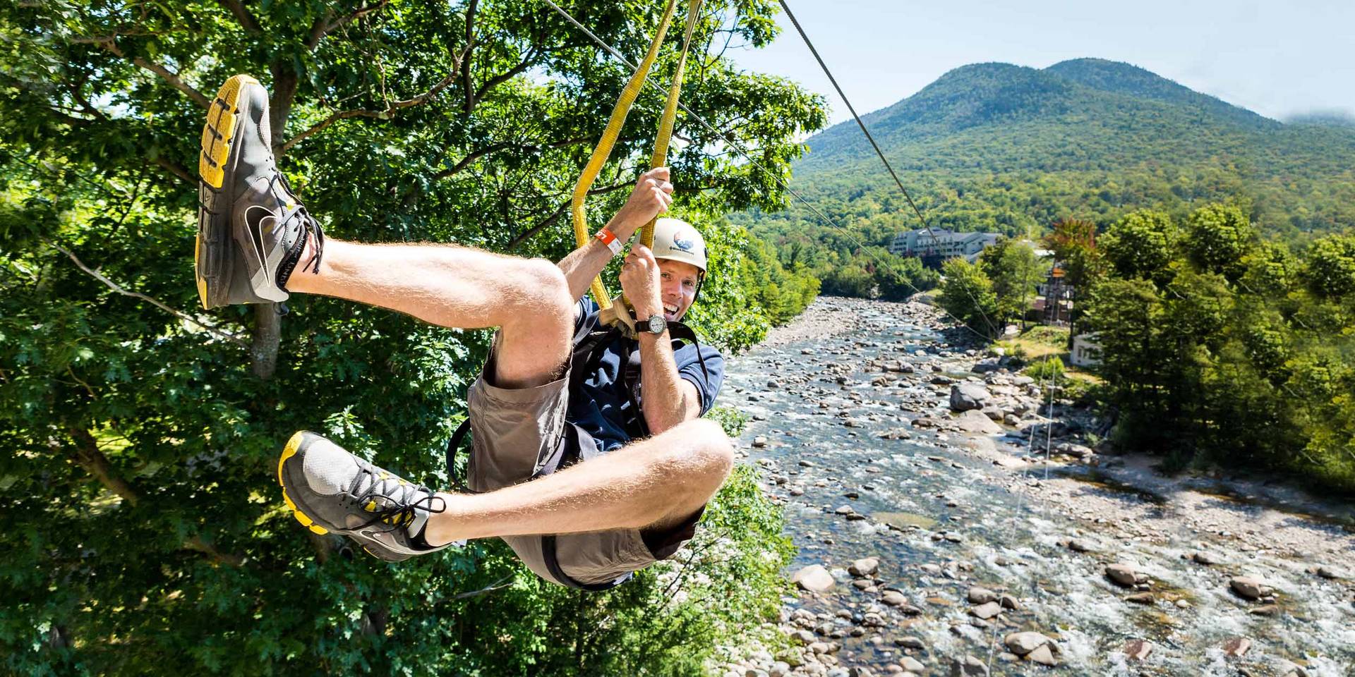 Zipliner crossing the Pemi River