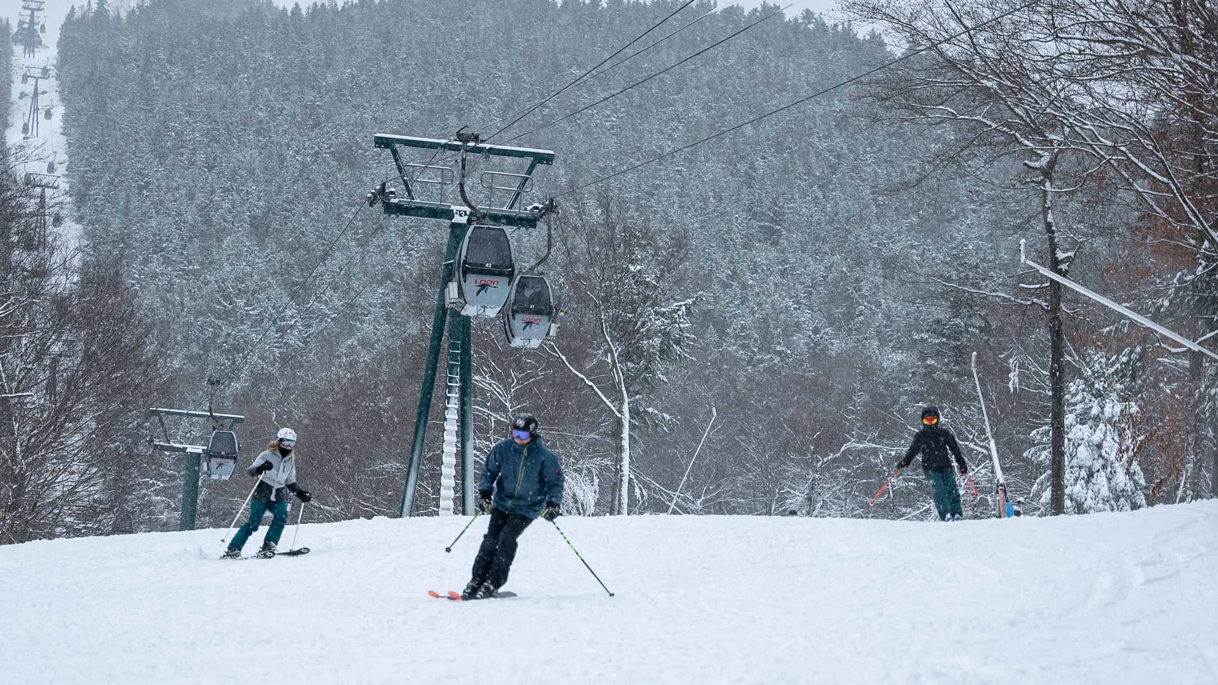 Three skiers skiing on average terrain.