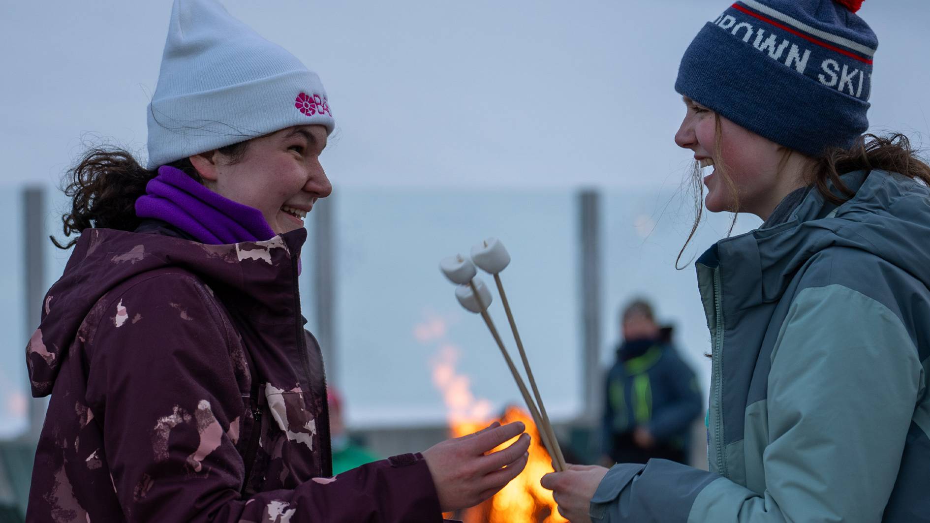 Two girls with marshmallows on sticks