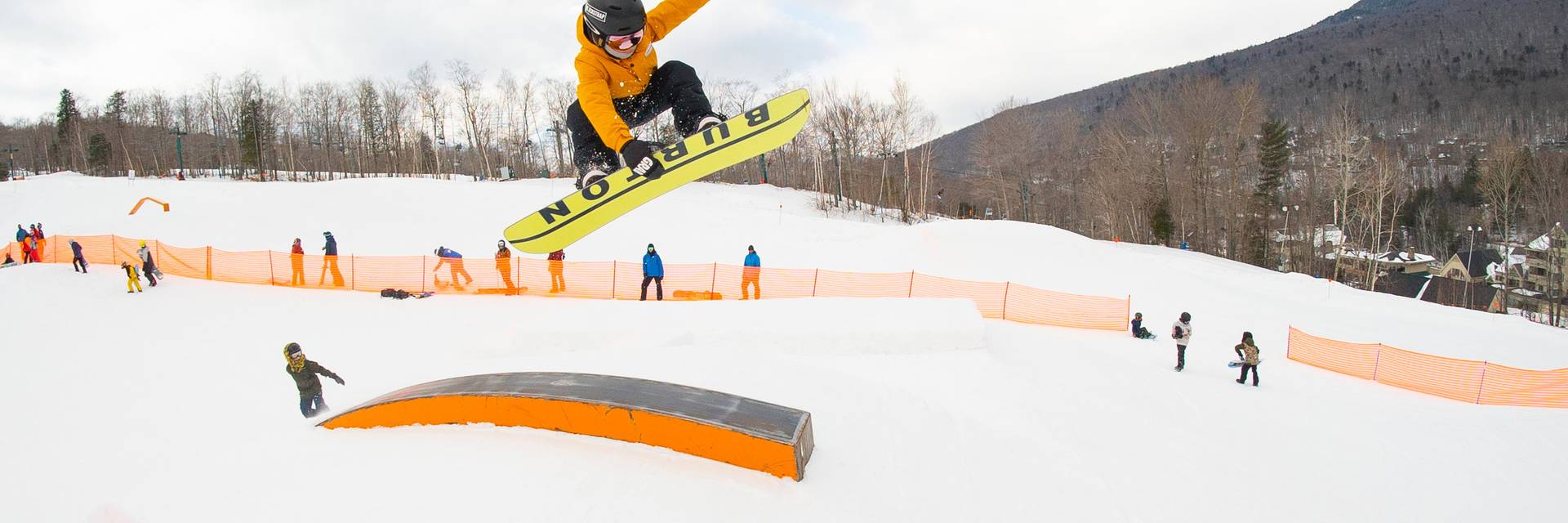 snowboarder riding rail