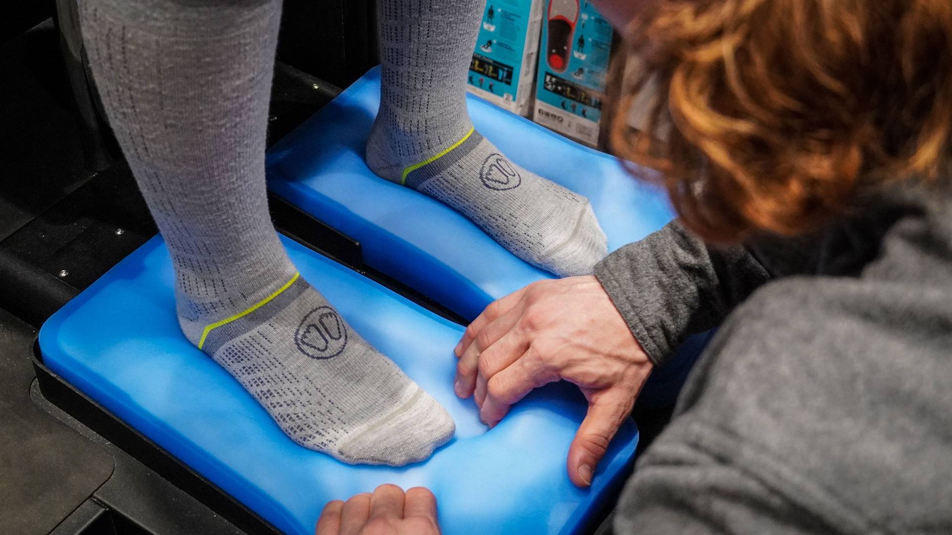 Master bootfitter using a device to make an impression of the customer's foot