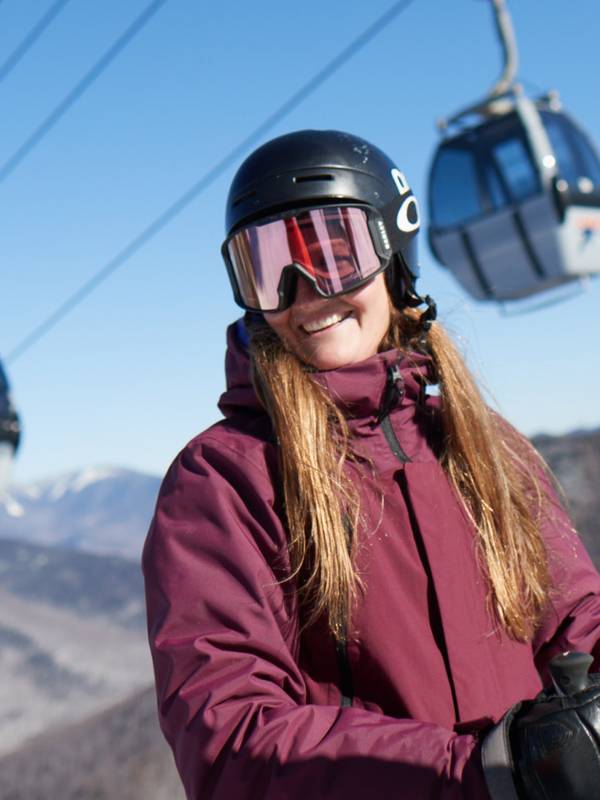 Skier smiling with gondola at Loon Mountain Resort