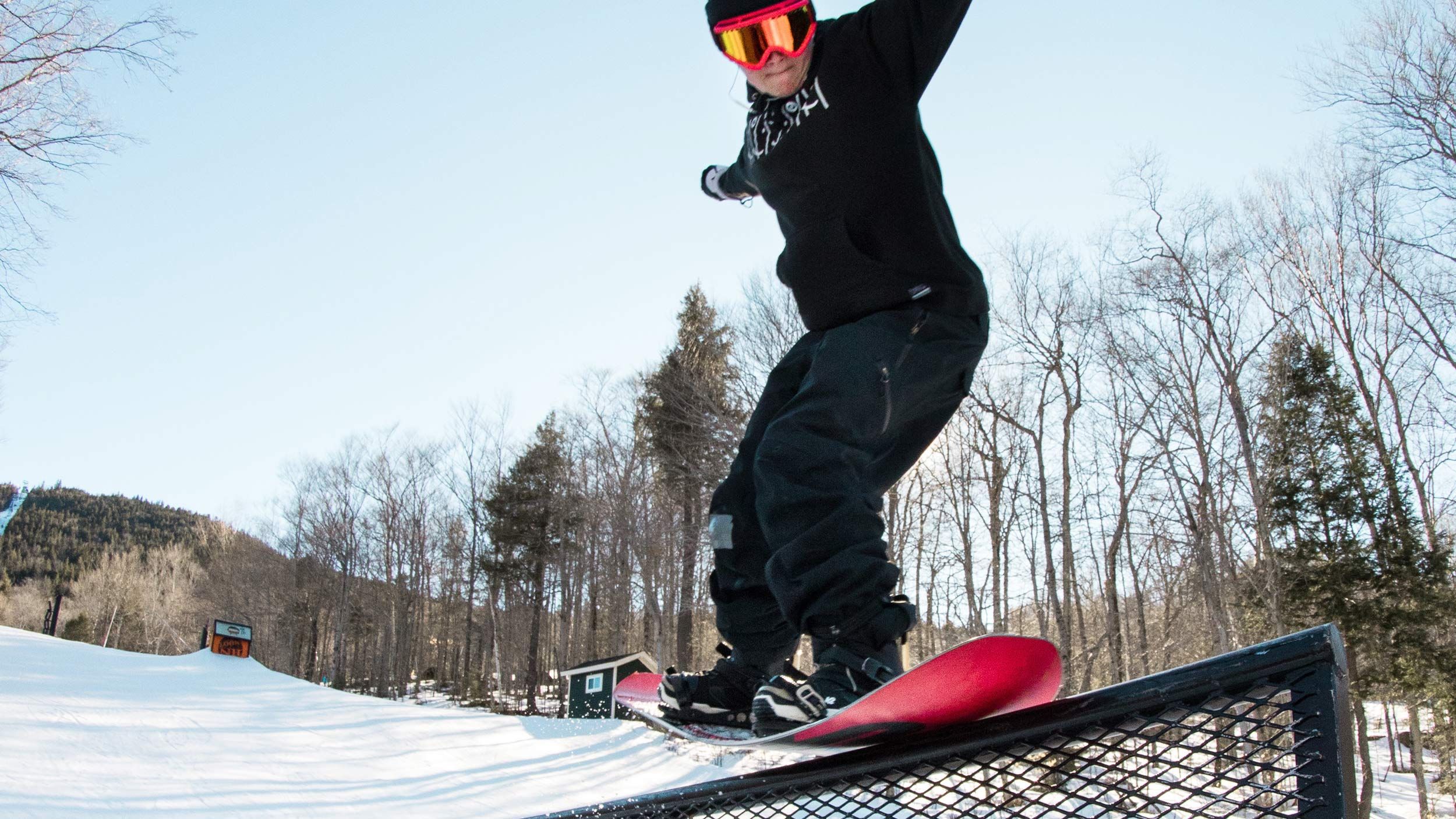 Girl snowboarder riding rail