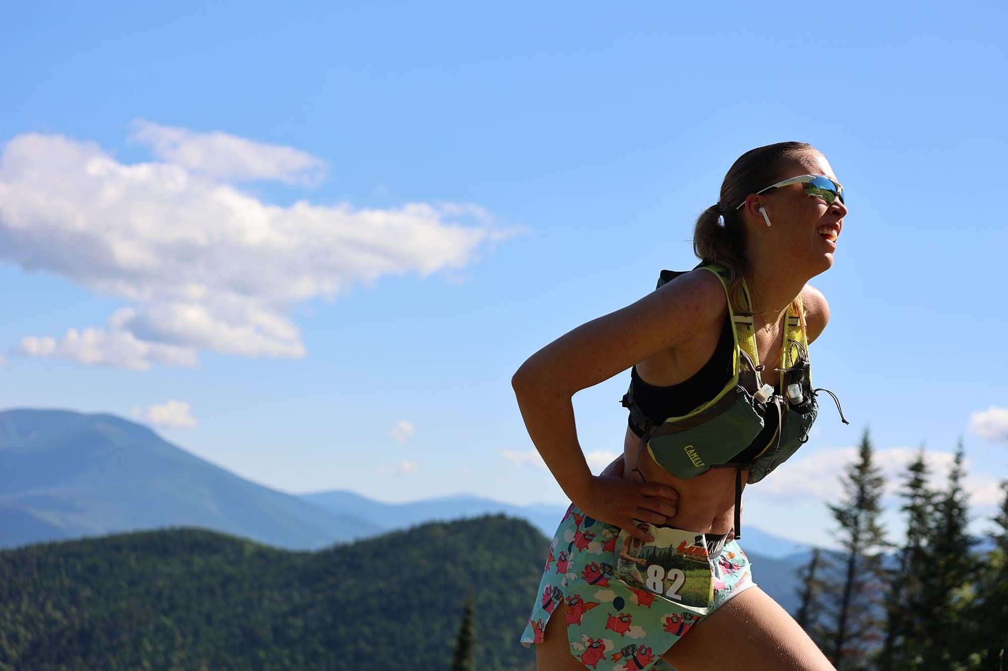 female runner wearing with mountains in background