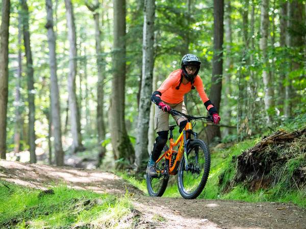 Woman riding mountain bike in the summer.