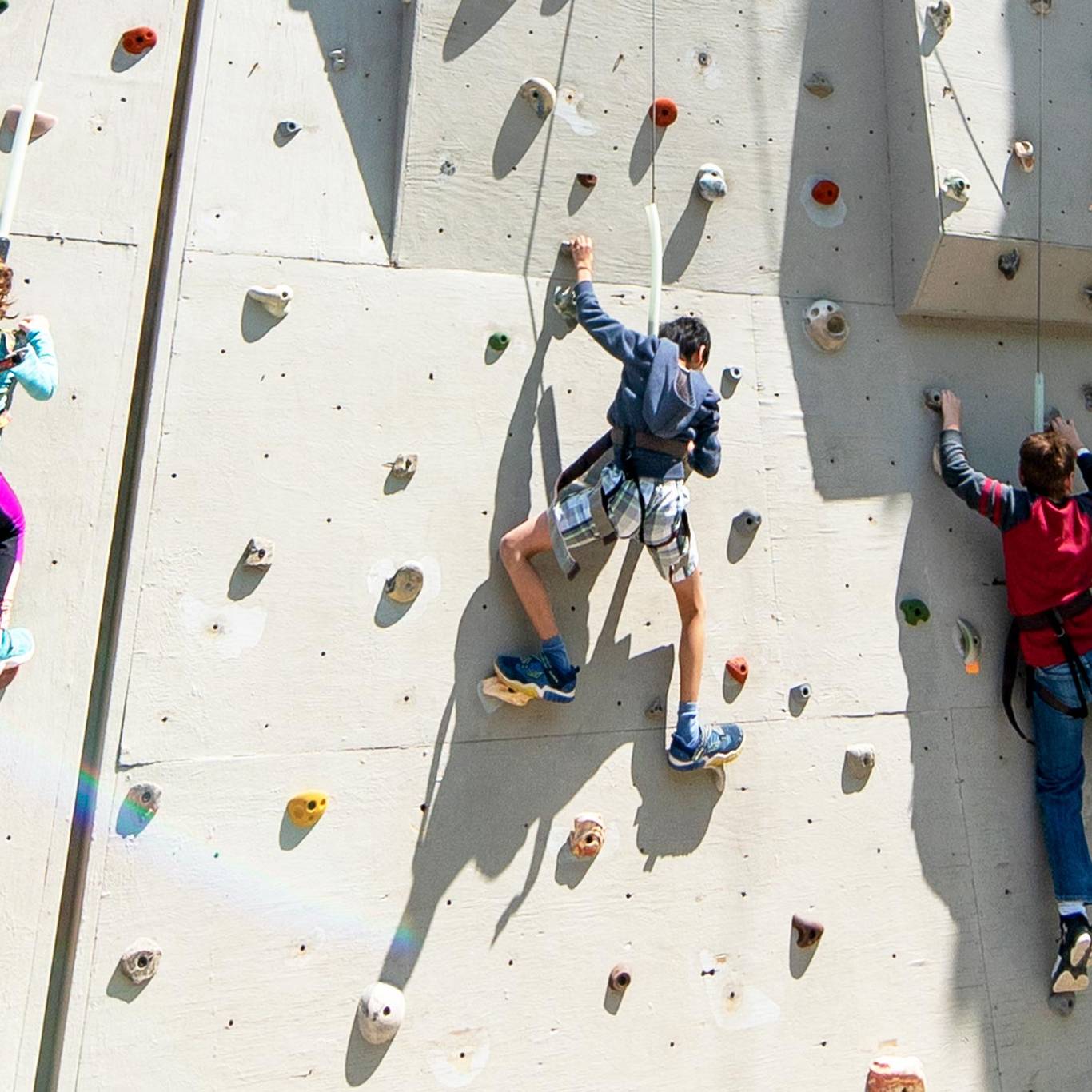 3 kids on the climbing wall