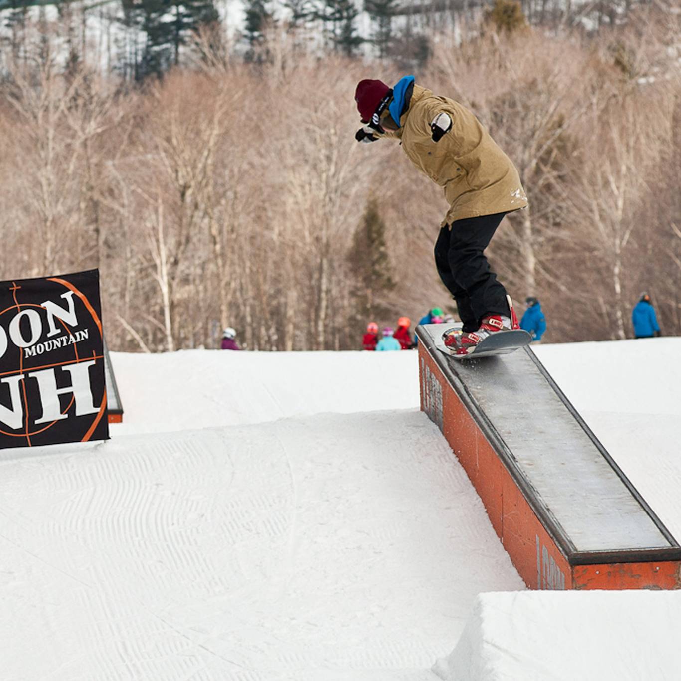 Snowboarder riding a rail at Loon Mountain