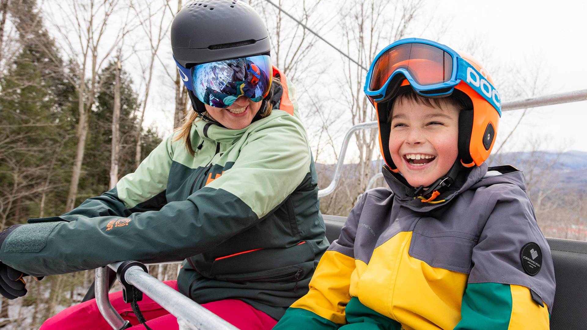 Mother and son having a good time while riding a chairlift at Loon Mountain