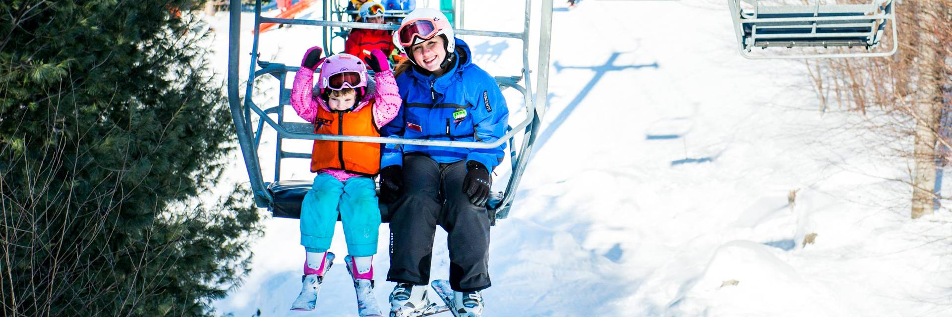 Scouts participant riding chairlift with instructor